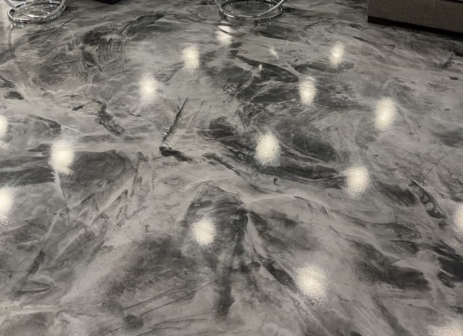 High-gloss storm-marble metallic epoxy floor with mirror light reflections, finished by Epoxy Dept in the Coachella Valley