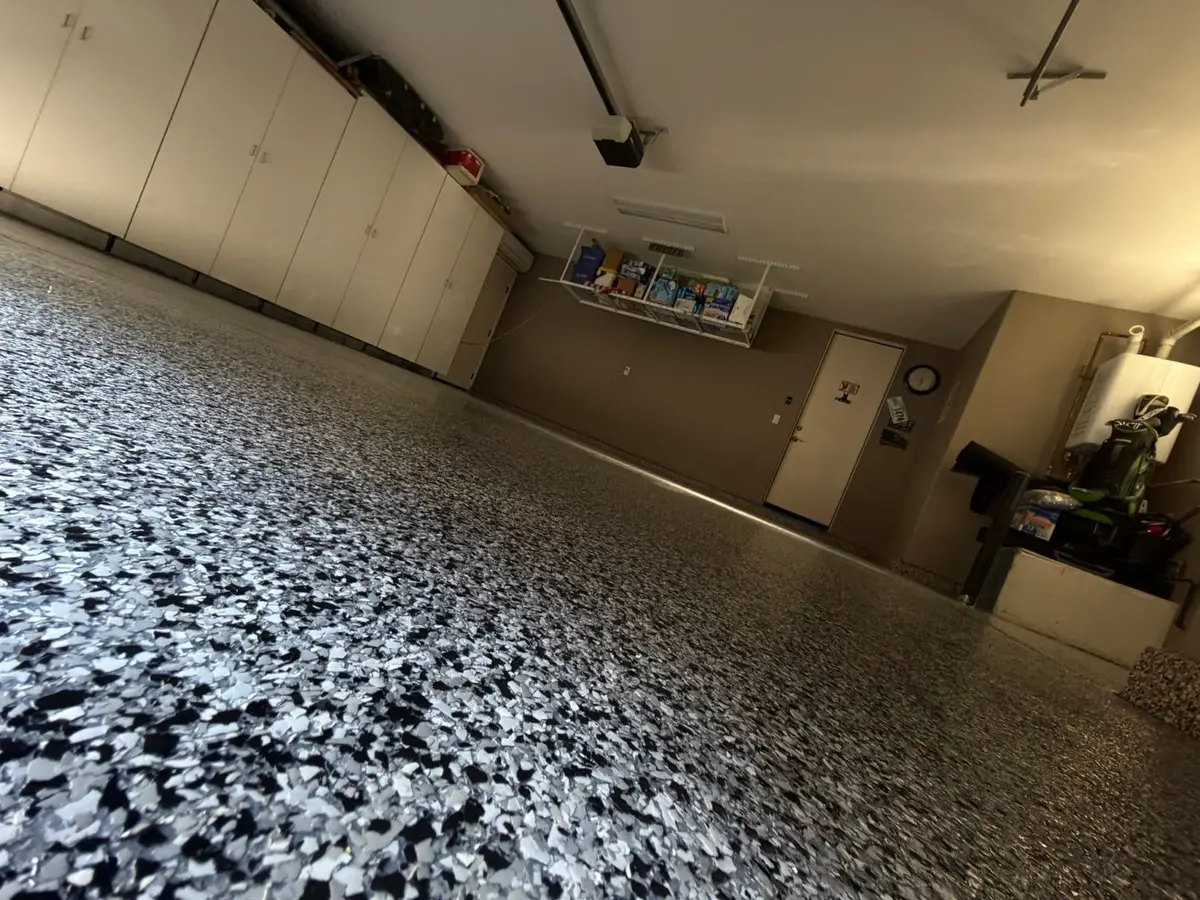 Blue and gray flake epoxy garage floor with cabinets, finished by Epoxy Dept